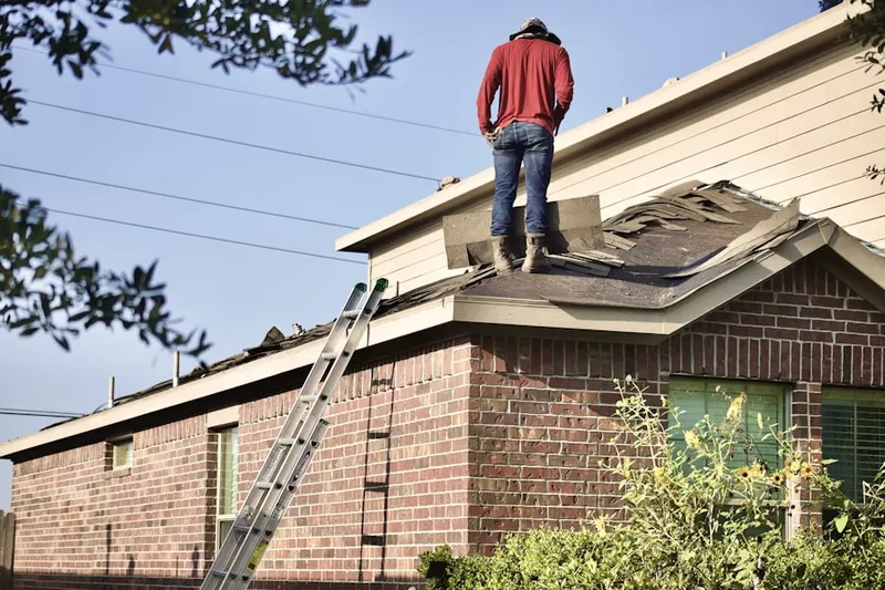 Professional roofer working on a residential roof in South Pines